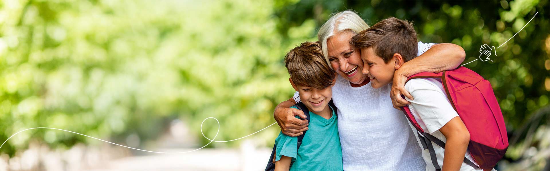 A laughing grandmother hugs her two grandsons